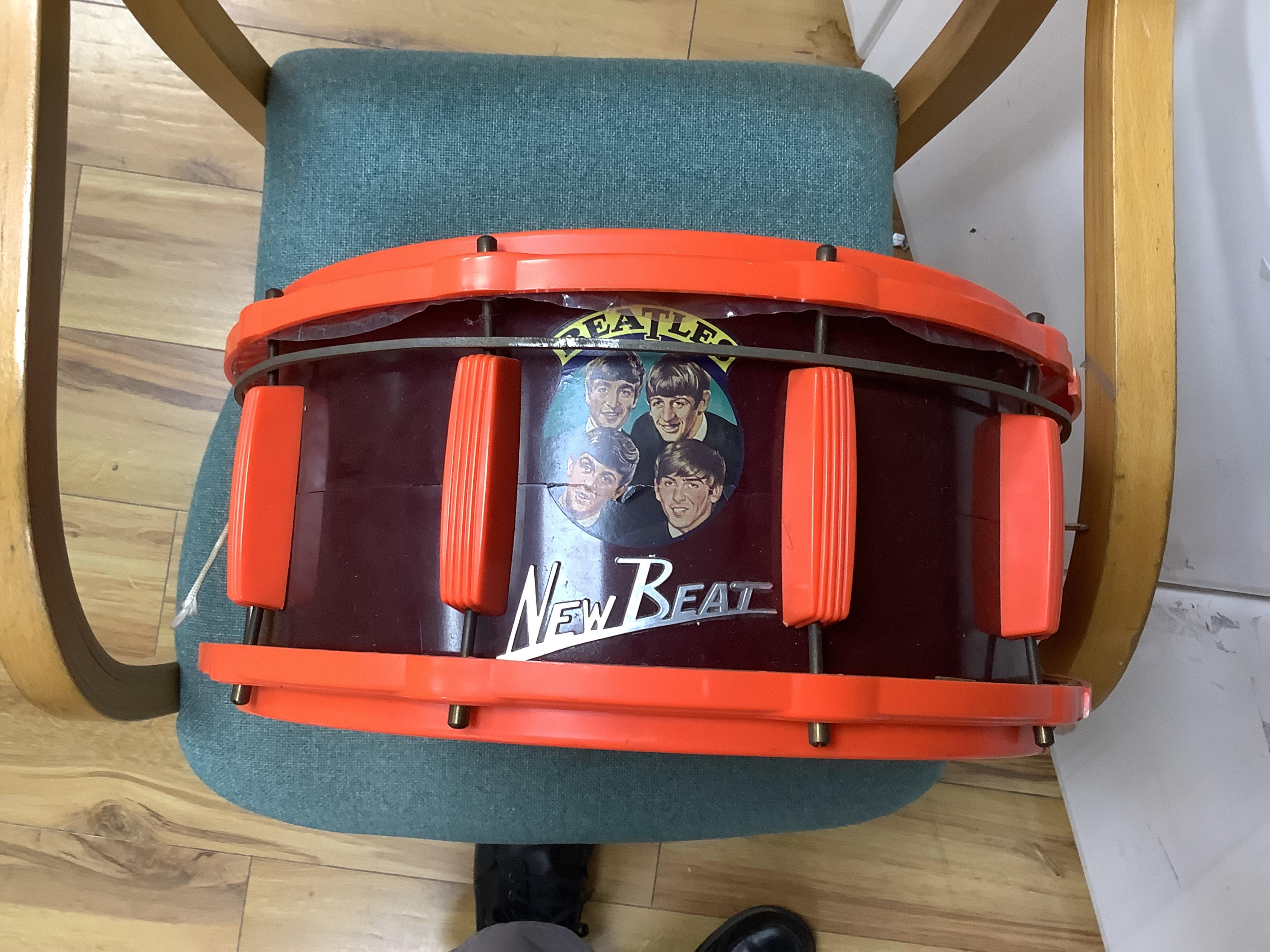 A 1960's Beatles child's plastic drum set in the original card box comprising of a snare drum on a stand, a card cut out bust of Ringo Starr, two 1960s Beatles jigsaws (unchecked) and a Beatles inflatable ball